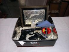 A Harrington air pistol A/F, a novelty gun cigarette lighter and a Samuel Colt advertising mirror
