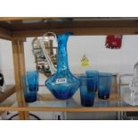 A blue glass jug and five tumblers.