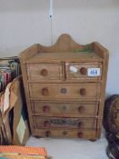 A table top six drawer chest.