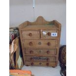 A table top six drawer chest.