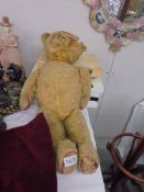 A vintage jointed teddy bear.