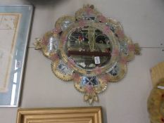 A circular mirror with glass flower decoration. COLLECT ONLY.