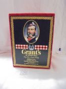 A boxed Grant's 25 years old very rare Scotch whisky with Royal Doulton William Grant character jug.