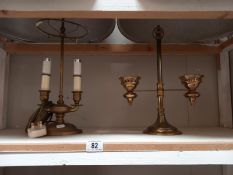 A brass light fitting plus brass candle holder