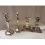 Two pairs of silver plate candlesticks.