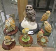 Six owl figures including a clock.