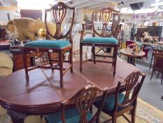 A mahogany oval extending dining table with one carver and five dining chairs, COLLECT ONLY.