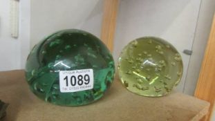 Two large old glass paperweights.