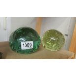 Two large old glass paperweights.