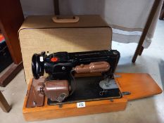 A cased electric Singer sewing machine & accessories COLLECT ONLY