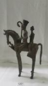 A bronze African man and woman on horse figure, 34 cm tall, age unknown.