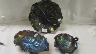 Three purple carnival glass dishes.