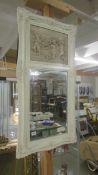 A white framed bevel edged mirror with Cherub freize at top, 117 x 60 cm. COLLECT ONLY.