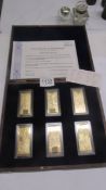 A cased set of six gold plated pound ingots with certificate.