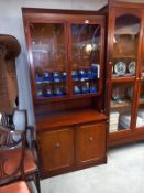 A dark wood stained wall unit with cut glass doors (45cm x 92cm x 196cm high)