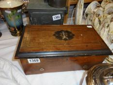A Victorian mahogany cased music box in working order.