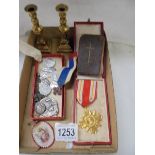 A mixed lot of religious items including Popes Medal, brass candlesticks etc.,