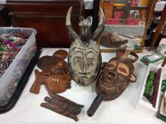 A quantity of wooden wall masks.