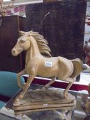 A carved wood horse statue. COLLECT ONLY.