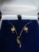 A three piece white gold diamond pendant and earring set, 9ct.