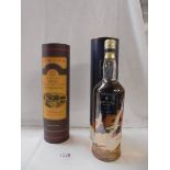 A bottle of Glenmorangie and a bottle of Bowmore Surf single malt Scotch whisky.