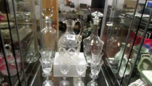 Three glass decanter and six etched glasses.