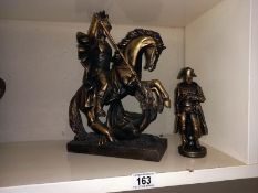 A bronzed resin figure of a Roman on horseback and a figure of Napoleon.