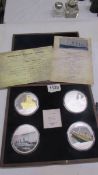 A cased set of four 'Titanic Tribute' coin set.