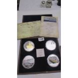 A cased set of four 'Titanic Tribute' coin set.