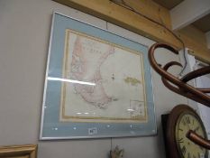 A framed and glazed map of South America.