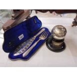 A cased pair of fish servers and a bowling trophy.