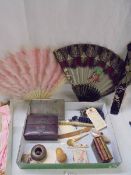 A mixed lot including 2 fans, cigarette case, miniature books etc.,