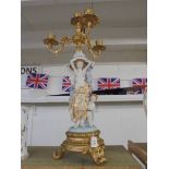 A gilded and porcelain candelabra supported by figures. COLLECT ONLY.