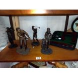 4 golf related figures and a cased as new putter with balls