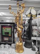 A tall gilded cherub candelabra, COLLECT ONLY.