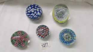 Five good millifiori glass paperweights.