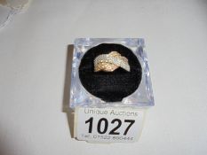 A yellow gold cross over diamond ring, estimated 130 - 150 pts, size P, 3.6 grams.