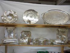 Two silver plate trays, 3 silver plate tureens, 3 silver plate baskets, a silver plate tea set,