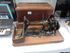 A cased vintage Singer sewing machine. COLLECT ONLY.