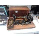 A cased vintage Singer sewing machine. COLLECT ONLY.