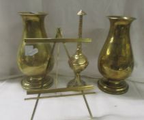 A pair of heavy brass vases, a brass finial and a brass easel photo frame.