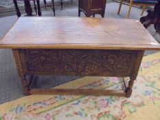 A heavy oak carved front coffer/chest with vine & grape decoration. COLLECT ONLY.