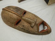 An African ceremonial mask, 67 x 20 cm.