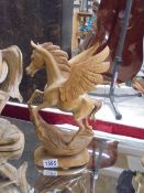 A carved wood Pegasus figure.
