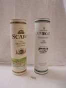 A bottle of Scapa single malt and a bottle of Laphroaig single malt whisky.