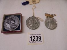 An Edward VIII medallion, a 1911 coronation medallion and one other.