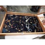 A pine jewellers display cabinet with an array of assorted costume jewellery