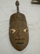 A West African style wall mask, 47 x 12 cm.