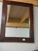 A bevel edged mirror in oak frame. COLLECT ONLY.