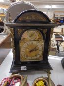 An ebonised ormolu mounted 19th century bracket clock with brass dial.